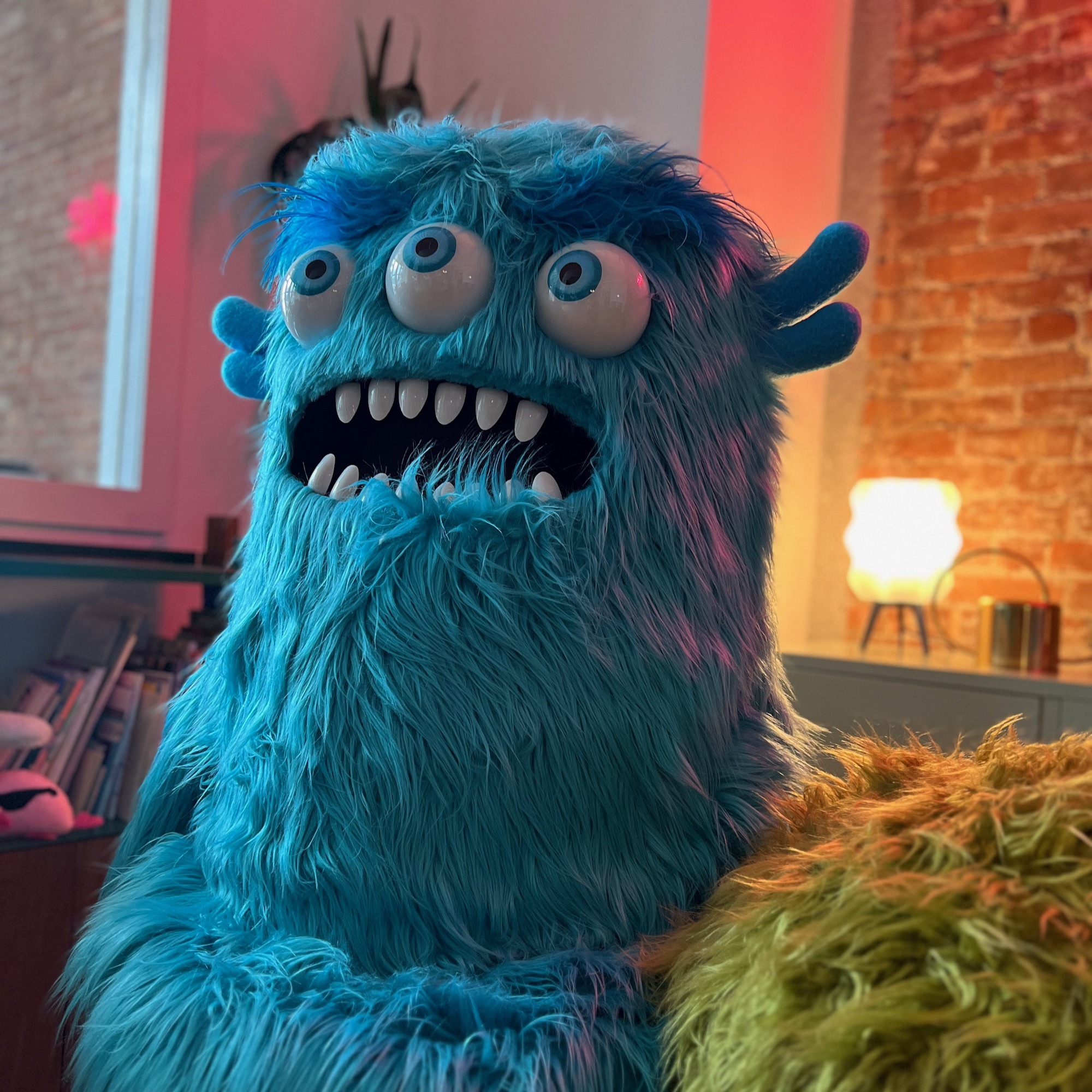 Three-eyed blue furry monster puppet by Furry Puppet Studio