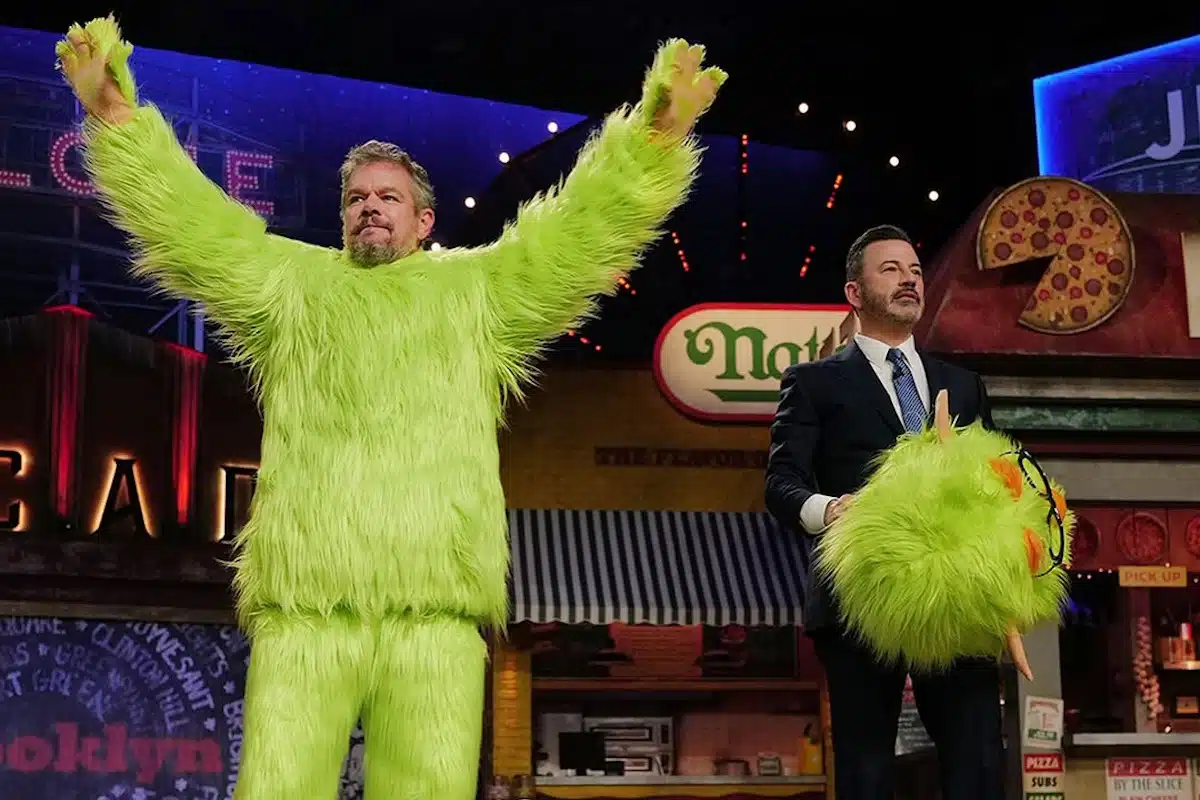 Matt Damon in the green Frankie Focus mascot suit beside Jimmy Kimmel on Jimmy Kimmel Live